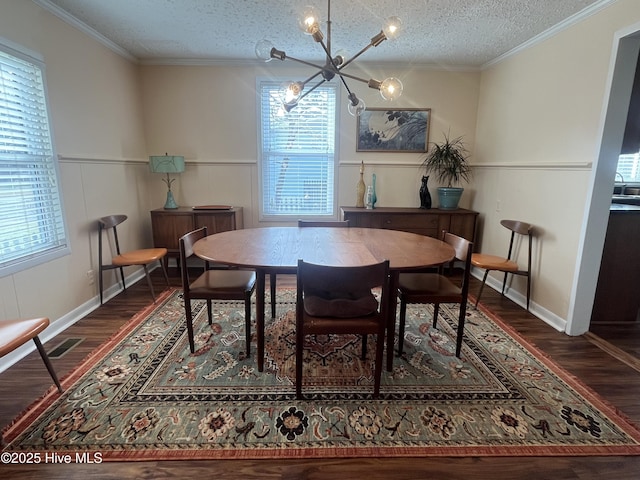 dining area with a chandelier, visible vents, a textured ceiling, and ornamental molding