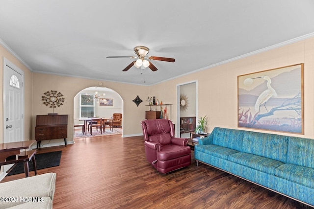 living room featuring arched walkways, wood finished floors, a ceiling fan, and crown molding