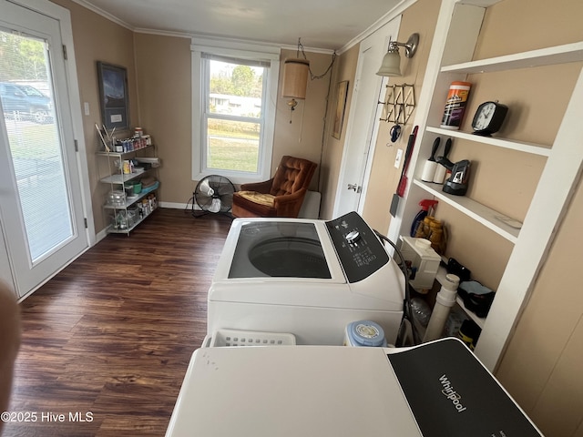 clothes washing area featuring washing machine and dryer, wood finished floors, crown molding, baseboards, and laundry area