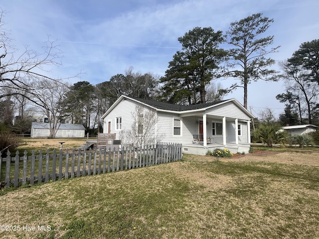 view of front of home with crawl space, a fenced front yard, covered porch, and a front lawn