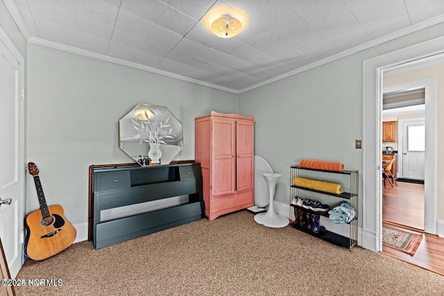 miscellaneous room with carpet flooring and crown molding