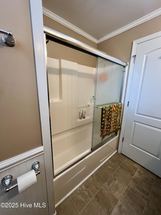 bathroom featuring tile patterned floors, crown molding, and bath / shower combo with glass door