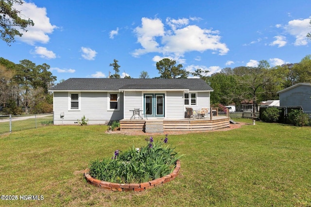 back of property with a deck, a fenced backyard, a lawn, and crawl space