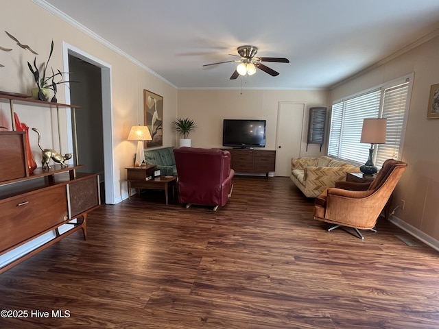 living area with dark wood-type flooring, crown molding, and ceiling fan