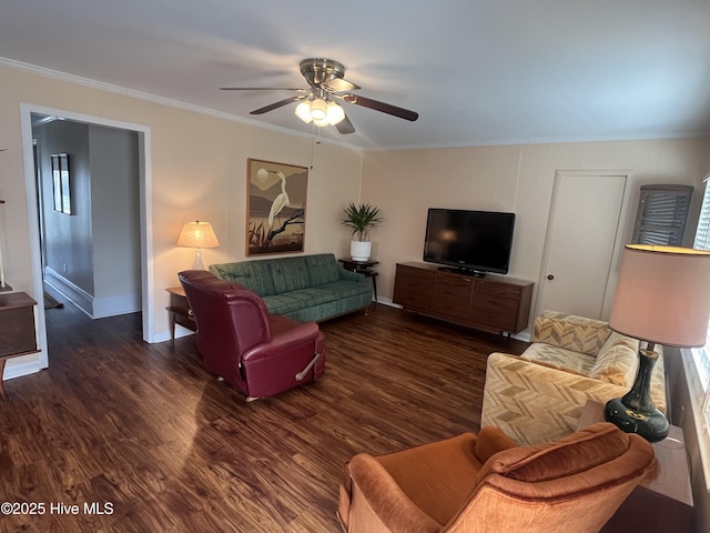 living room featuring baseboards, crown molding, ceiling fan, and wood finished floors