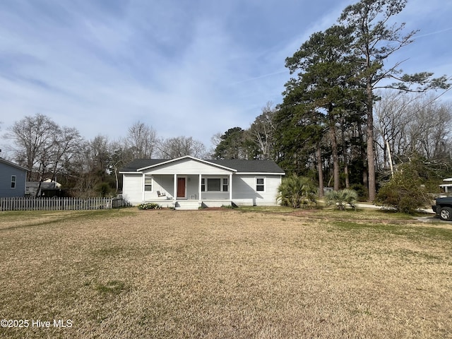 view of front facade with a front yard and fence