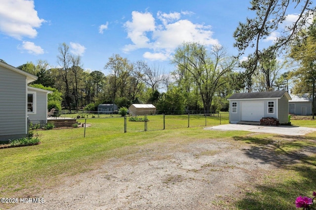 view of yard with an outbuilding and fence