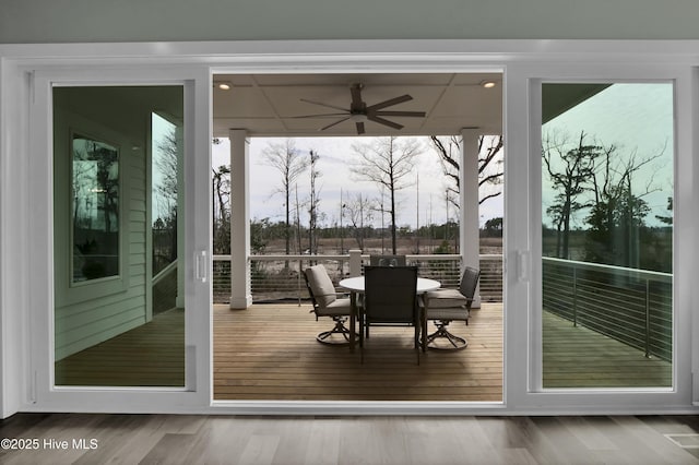 doorway featuring ceiling fan and wood finished floors