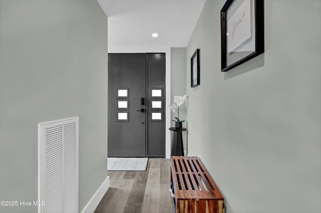 interior space with recessed lighting, visible vents, baseboards, and wood finished floors