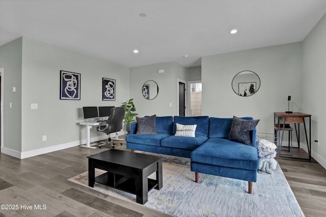 living room with recessed lighting, baseboards, and wood finished floors