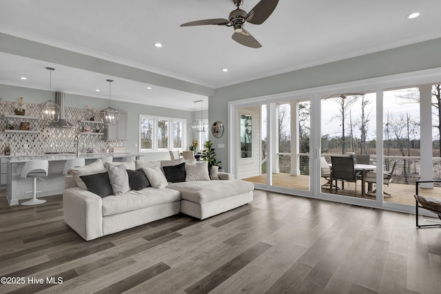 living room featuring dark wood finished floors, recessed lighting, ceiling fan, and ornamental molding