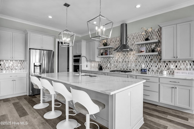 kitchen featuring open shelves, a sink, stainless steel appliances, crown molding, and wall chimney range hood