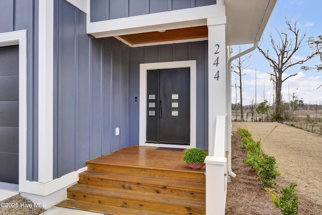 view of exterior entry with board and batten siding