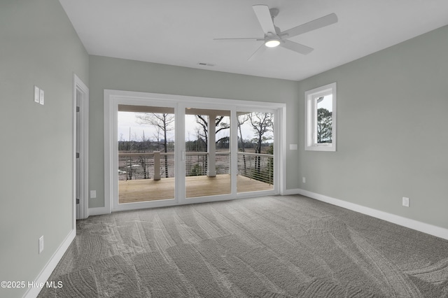 spare room with visible vents, carpet, baseboards, and ceiling fan