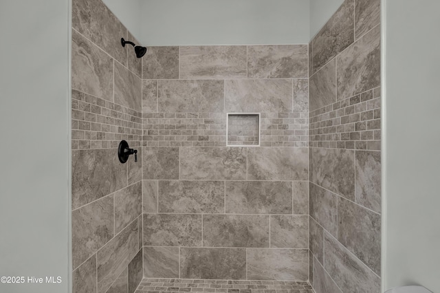 full bath featuring tiled shower