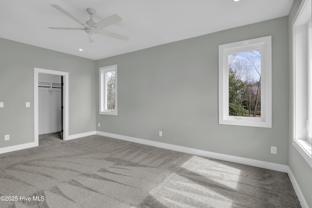 unfurnished bedroom with multiple windows, baseboards, and carpet floors