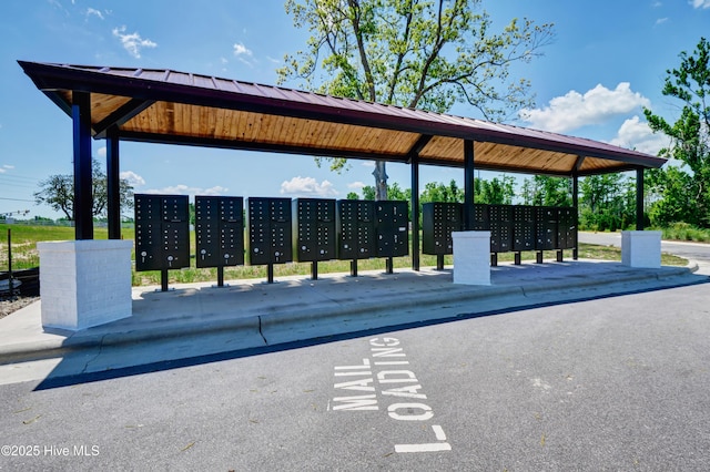 view of community with mail area and a parking lot