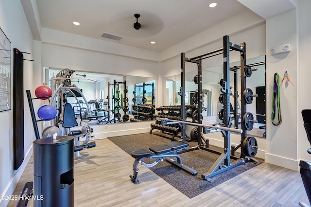 workout area featuring visible vents, recessed lighting, baseboards, and wood finished floors