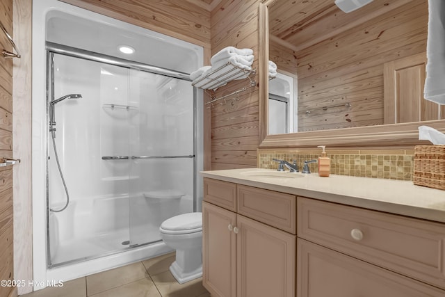 bathroom with vanity, a stall shower, decorative backsplash, tile patterned floors, and toilet