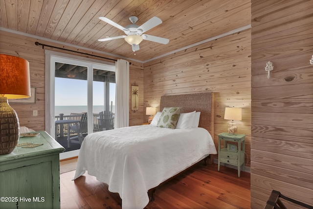 bedroom featuring access to exterior, wooden walls, wood finished floors, and wooden ceiling