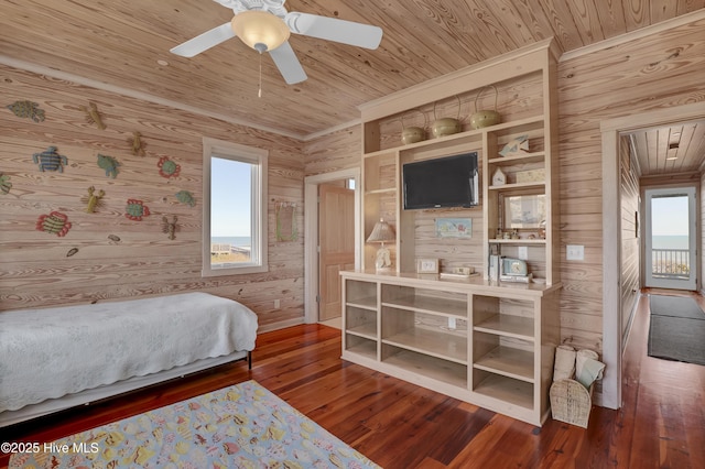 bedroom with multiple windows, wood ceiling, wood walls, and hardwood / wood-style floors