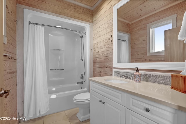 full bath featuring toilet, shower / bath combo, wood walls, tile patterned flooring, and vanity