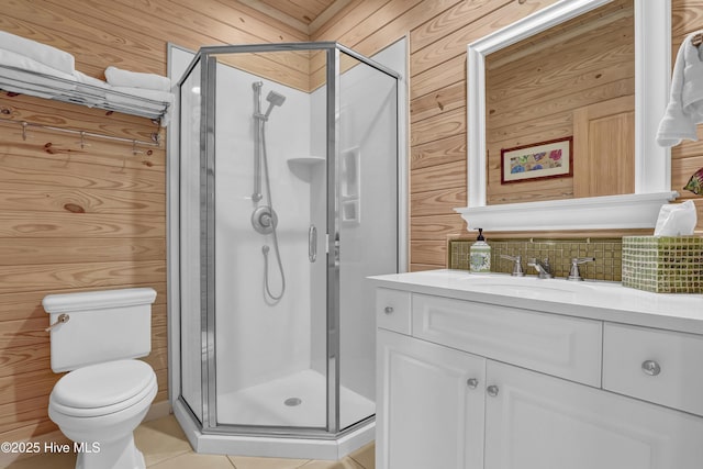 bathroom with decorative backsplash, a stall shower, toilet, and vanity