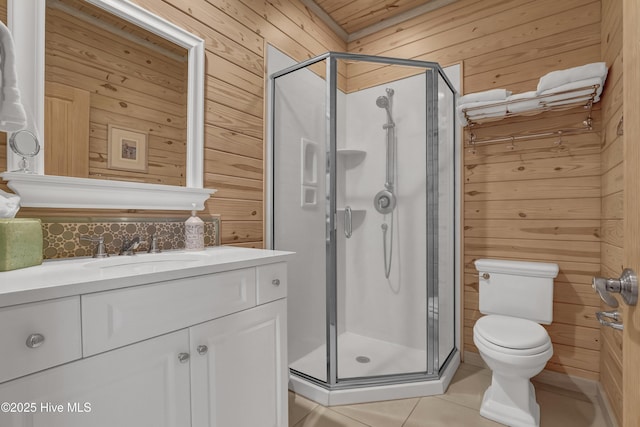 bathroom with tile patterned flooring, wooden walls, and a shower stall