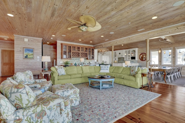 living area with recessed lighting, wood ceiling, wood finished floors, and wood walls