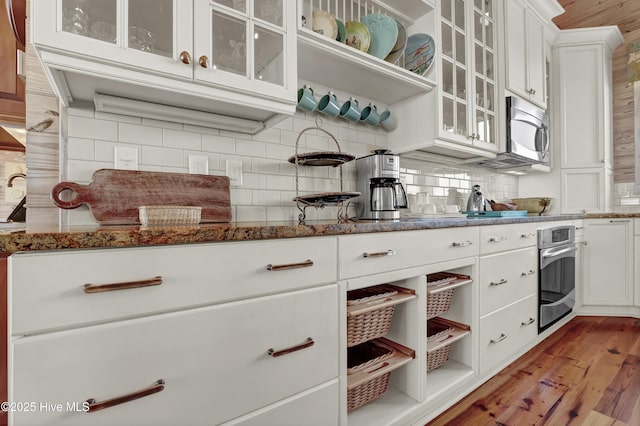 kitchen featuring open shelves, white cabinets, backsplash, and stainless steel appliances