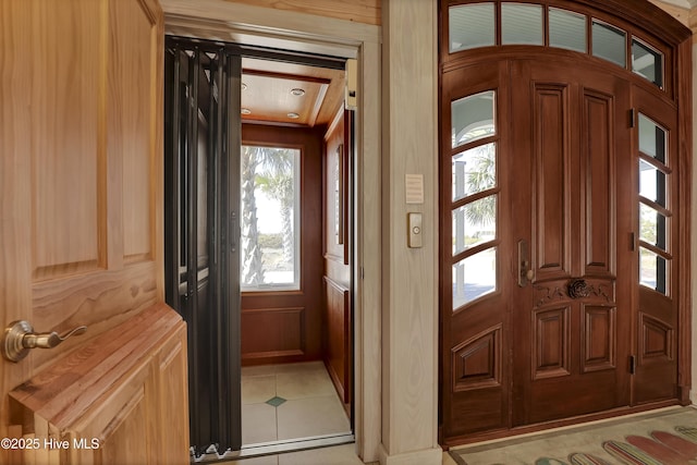 entryway with light tile patterned floors and elevator