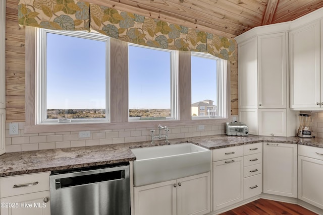 kitchen featuring tasteful backsplash, white cabinets, dishwasher, and a sink