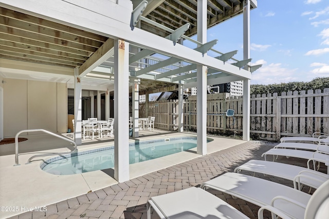 view of swimming pool featuring a patio area, a fenced in pool, fence, and a pergola