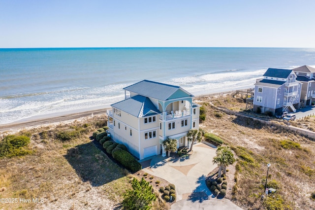 birds eye view of property featuring a water view and a beach view