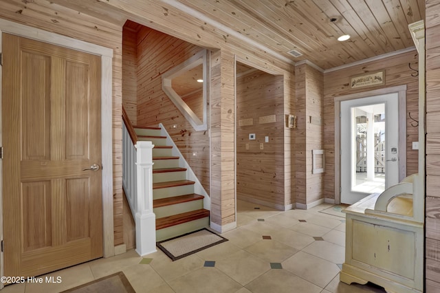 interior space featuring tile patterned floors, wood walls, and wood ceiling