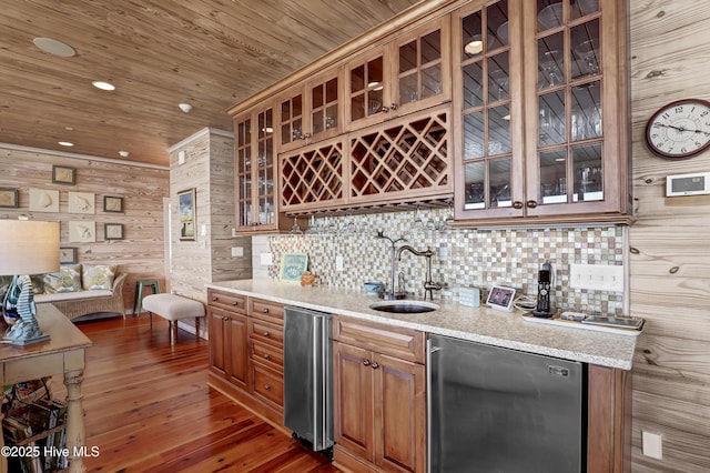 bar with a sink, indoor wet bar, wood ceiling, fridge, and backsplash