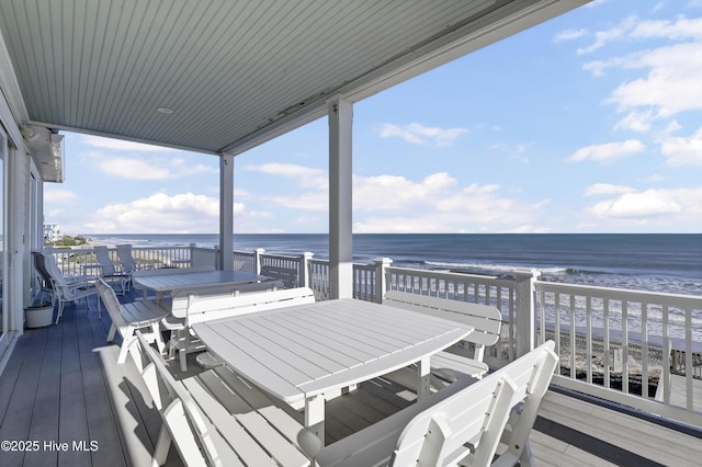 deck featuring a water view and a view of the beach