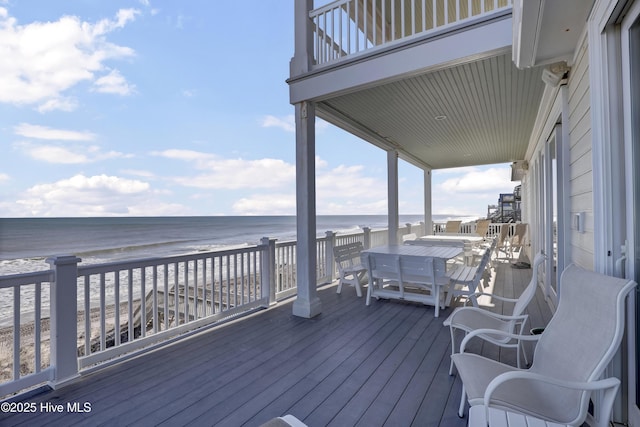 deck with a water view and a beach view