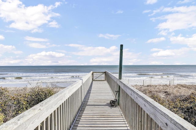 view of home's community featuring a beach view and a water view