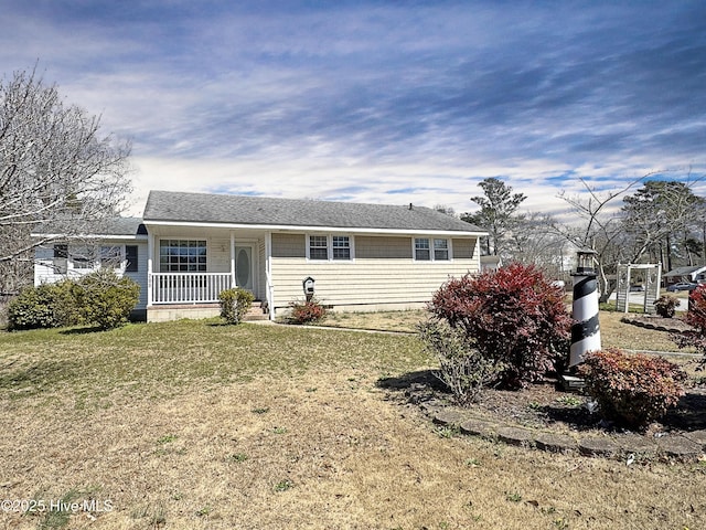 ranch-style home featuring a porch, a front lawn, and roof with shingles