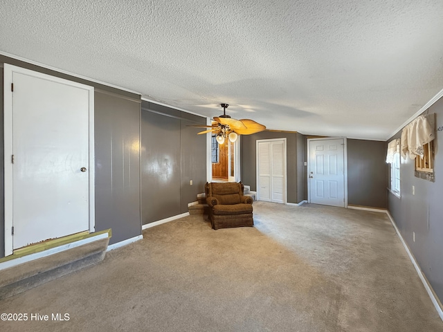 unfurnished room with baseboards, a textured ceiling, ceiling fan, and carpet flooring