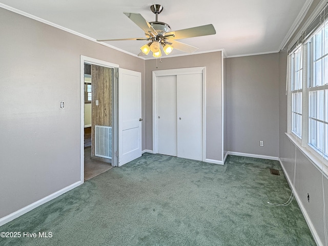 unfurnished bedroom with visible vents, carpet floors, a closet, and ornamental molding