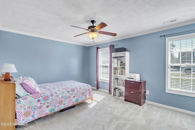 carpeted bedroom featuring a textured ceiling, baseboards, visible vents, and ornamental molding