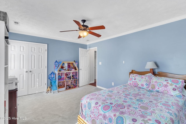 bedroom featuring carpet flooring, visible vents, a closet, and ornamental molding