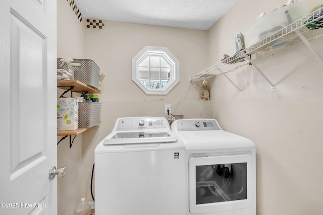 laundry room with laundry area, independent washer and dryer, and a textured ceiling