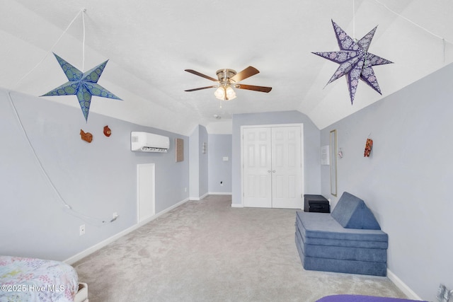 sitting room with lofted ceiling, a wall unit AC, carpet flooring, baseboards, and ceiling fan