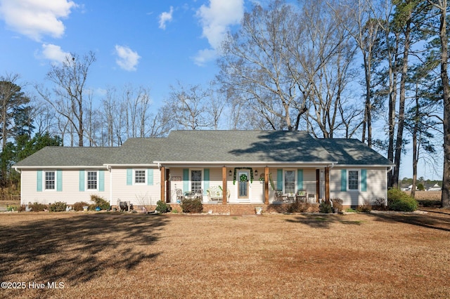 single story home with crawl space, covered porch, a front lawn, and a shingled roof