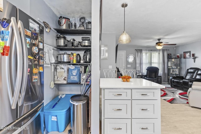 kitchen featuring wood finished floors, freestanding refrigerator, ceiling fan, white cabinetry, and open floor plan