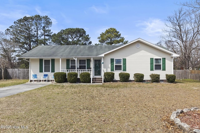 ranch-style home featuring a shingled roof, fence, covered porch, and crawl space