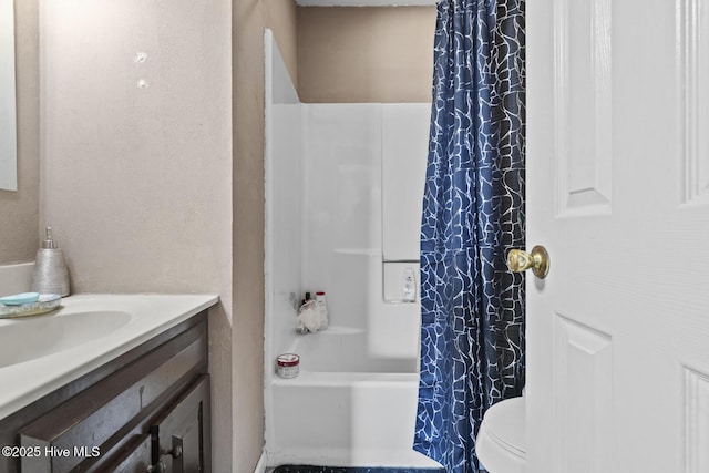 bathroom with vanity, shower / bath combination with curtain, and toilet